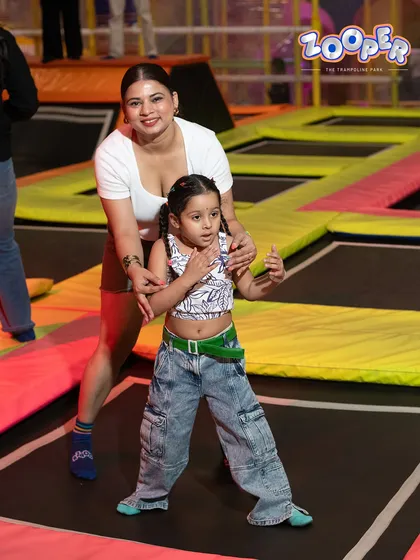 A mother helps her young daughter find her footing. We make sure even the littlest jumpers feel safe and confident.