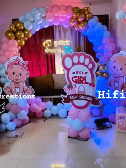 A gender reveal party setup in a home. We use "It's a Boy" and "It's a Girl" props along with a pink and blue balloon arch to build excitement for the big reveal.