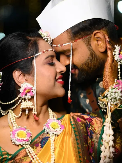A romantic close-up showcasing the bride's floral jhumkas and mundavalya. These small details make a big impact on the overall bridal look.