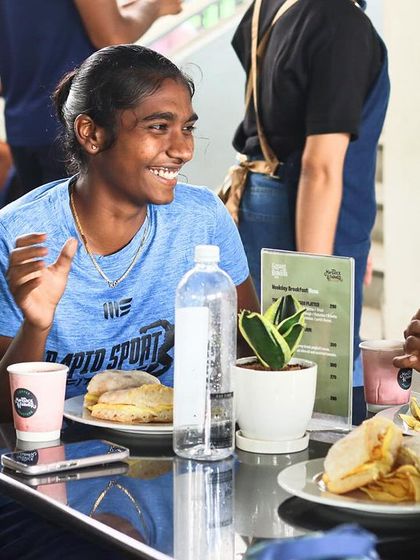 Athletes taking a well-deserved break and refueling between sessions. Recovery and community are just as important as the training itself, and we encourage moments of relaxation and connection.