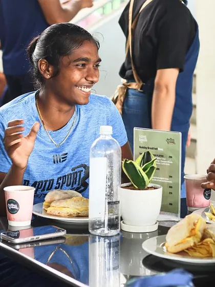 Female athletes enjoying a meal and conversation between sessions. A strong community and positive environment are key components of our training camps.