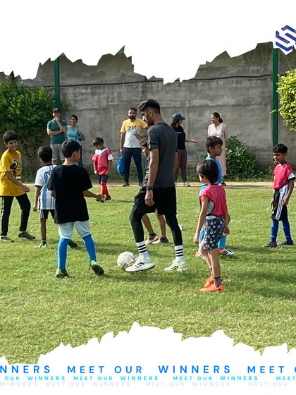 A coach guides a group of young players through a positioning drill. This kind of hands-on instruction is crucial for developing game awareness and learning to work together as a cohesive unit on the field.