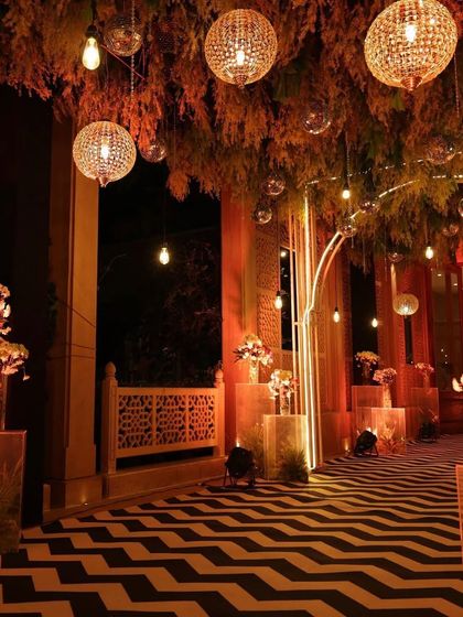 Another angle of this elegant Sangeet entrance, showing the hanging disco balls and crystal chandeliers that added a touch of sparkle and glamour to the warm, inviting ambiance.