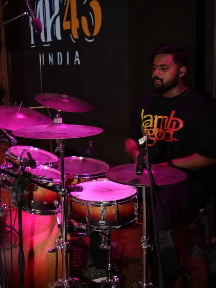 Beats that move the crowd. A shot of our drummer, focused and in the zone, providing the pulse for every song.