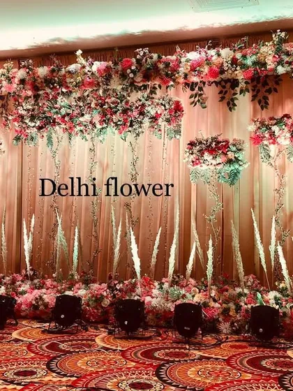 Another angle of the elegant indoor stage, highlighting the hanging crystal strings and the lush floral border.