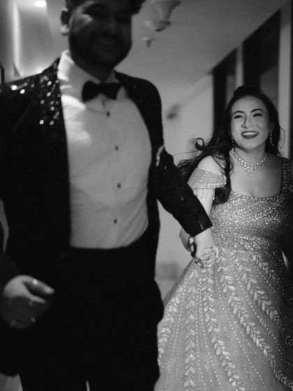 A candid moment of joy and movement. Animesh and Rashmi walking together, their laughter captured in a blur of happiness, perfectly conveys the energy of their reception.