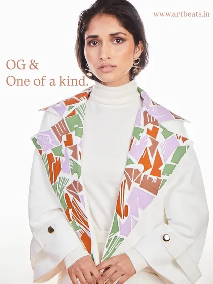 OG and one of a kind. The oversized lapels of this white trench coat are covered in my original, abstract artwork, making it a wearable masterpiece.