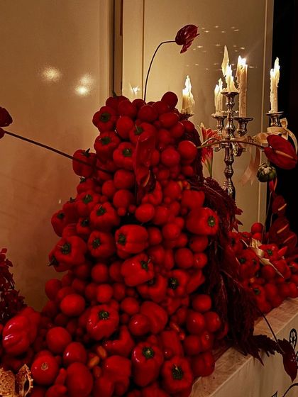 A dramatic centerpiece made entirely of red bell peppers and tomatoes, showcasing our creative and artistic approach to event decor.