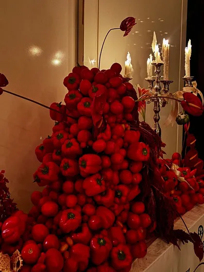 A dramatic centerpiece made entirely of red bell peppers and tomatoes, showcasing our creative and artistic approach to event decor.