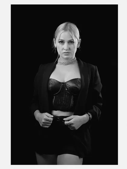 Sometimes, a simple black and white portrait says the most. This shot strips away color to focus on the model's direct gaze and expression, creating a timeless and classic image essential for any portfolio.