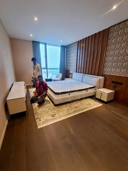 Unpacking happiness at a client's site in Bangalore. Our team is setting up a custom bedroom suite, including an upholstered bed, floating nightstands, and a sleek TV console.
