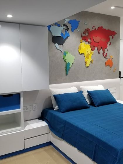 This kid's room is designed to inspire adventure. A colorful 3D world map serves as the headboard, creating a fun and educational focal point in a room filled with bright, cheerful colors.