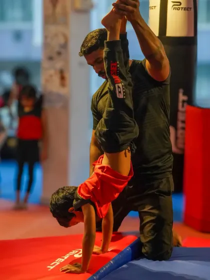 Even our youngest athletes learn foundational skills like the handstand with close supervision from our coaches. We focus on building upper body strength and balance in a fun, encouraging way for kids of all ages.