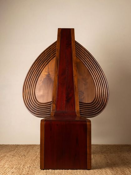 Various angles of the Vismayam chair, showcasing its intricate details, the contrast of different wood grains, and its powerful, sculptural presence. Each view offers a new perspective on this piece of collectible, art-inspired furniture.