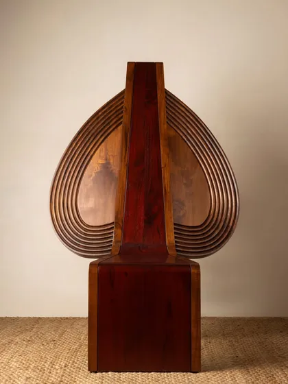 Various angles of the Vismayam chair, showcasing its intricate details, the contrast of different wood grains, and its powerful, sculptural presence. Each view offers a new perspective on this piece of collectible, art-inspired furniture.