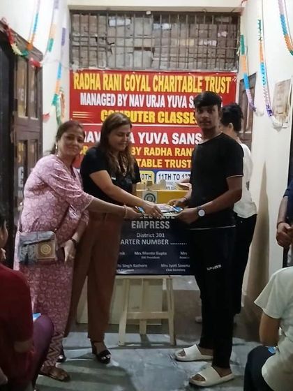 Distributing study materials to students during the Teachers' Day celebration. Providing resources for education goes hand in hand with teaching about health and wellness.