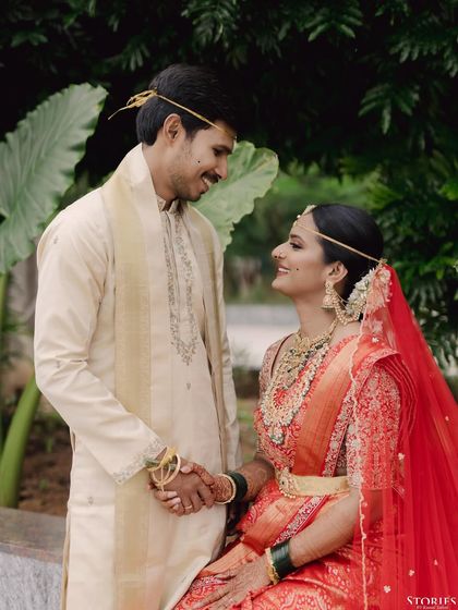A classic portrait of Nihal and Sravanthi, sharing a look of love and understanding after their wedding ceremony.