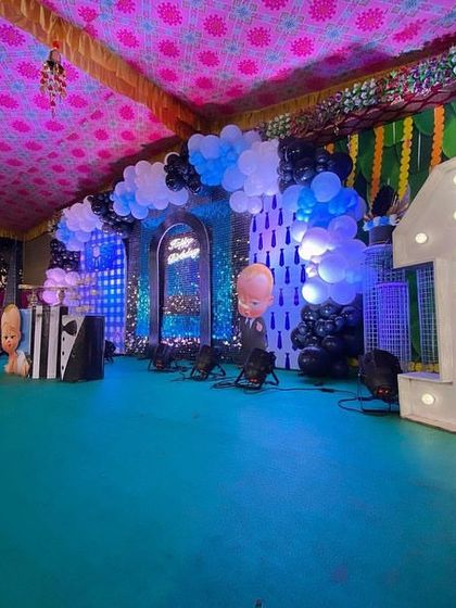 A wide-angle view of the Boss Baby setup, showing the large light-up number '1' and the full extent of the stage decorations.