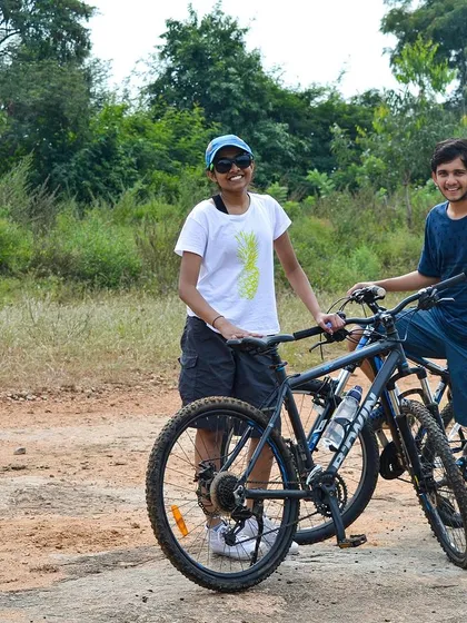 Two friends taking a break with their cycles during our Ramanagara off-road adventure.