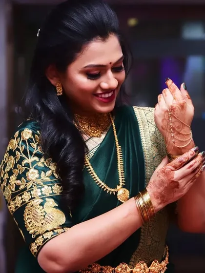This shot captures a lovely detail of the bride adjusting her hand jewelry, showing how the entire look, from makeup to accessories, comes together.