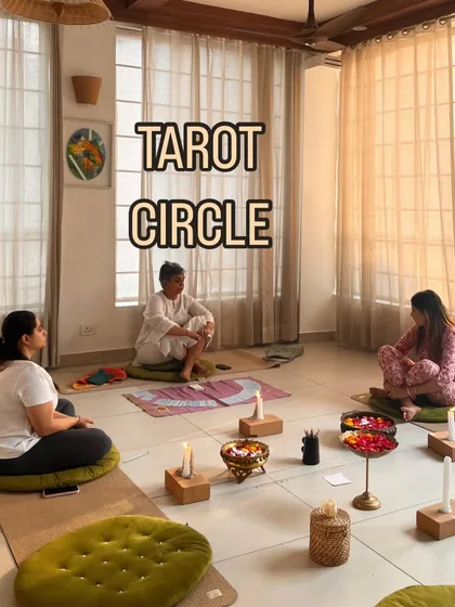The sacred setup of our Tarot Circle. Candles, flowers, and the cards laid out create a focused, intentional space for participants to connect with their intuition and the guidance offered.