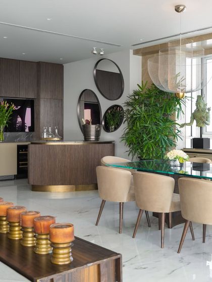 The dining area in the Camellias apartment, set within the larger living space. A custom bar from our Koko collection adds warmth and structure, while a glass-topped table and ethereal Moooi lights create a sense of lightness and poetry.