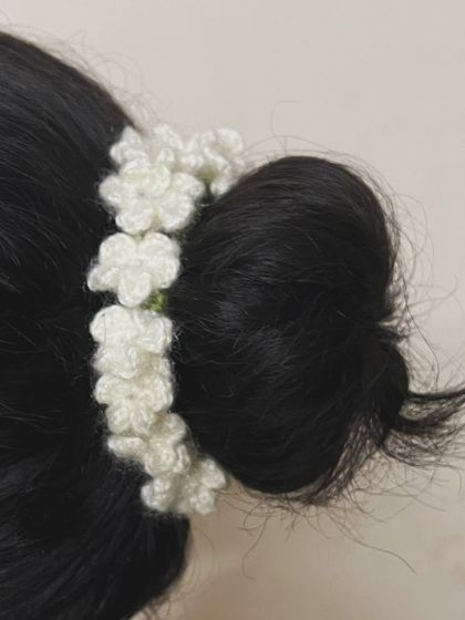 My crochet jasmine gajra worn as a hair tie around a bun. It’s a versatile piece that can be styled in multiple ways for a traditional look.