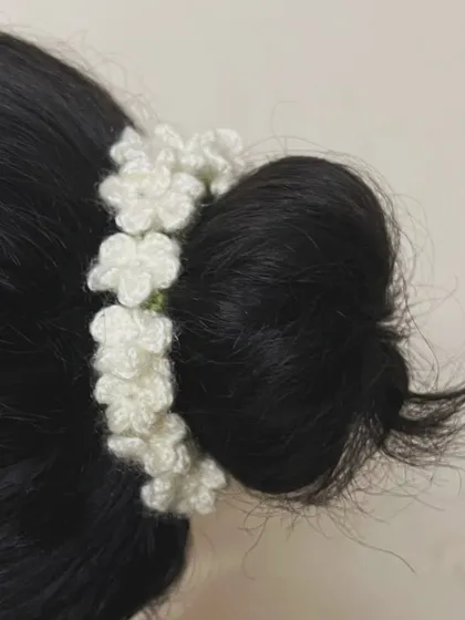 My crochet jasmine gajra worn as a hair tie around a bun. It’s a versatile piece that can be styled in multiple ways for a traditional look.