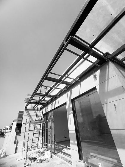 A wider view of the terrace overhang under construction, with scaffolding in place as the steel framework is completed.