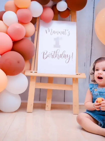 Before the smash! A beautiful portrait of a one-year-old girl in her birthday setup, complete with a balloon arch and a personalized sign.