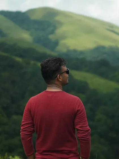 A creative shot looking out at the green hills of Chikmagalur, capturing the essence of a first-time trek.