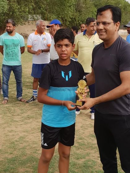 A young male player from our academy receiving his award. We focus on providing equal opportunities for both boys and girls to excel in the sport of basketball.