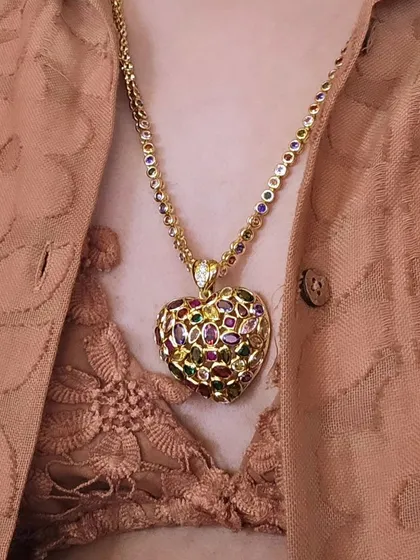 This stunning multi-gemstone heart pendant is the definition of a statement piece. Paired with a simple outfit, it adds a pop of color and luxury, proving that one great accessory is all you need.
