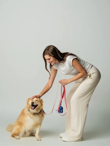 A happy dog makes for the best photos. In this lifestyle shot for Luxolandshop, a model gives a gentle pat to a smiling dog wearing one of their colorful harnesses. This kind of image creates a positive and warm feeling for the brand.