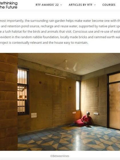 The surrounding rain garden and retention pond help manage water on the site, recharging the groundwater and supporting native plant species. This image shows a bedroom with Athangudi tile flooring and rammed earth walls.