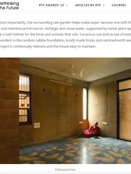 The surrounding rain garden and retention pond help manage water on the site, recharging the groundwater and supporting native plant species. This image shows a bedroom with Athangudi tile flooring and rammed earth walls.