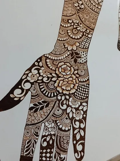 A full-hand design sketch on paper, combining floral, paisley, and geometric elements.