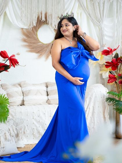 A stylish and modern look with a royal blue gown featuring a large bow. This portrait in our boho studio is perfect for the fashion-forward mom-to-be.