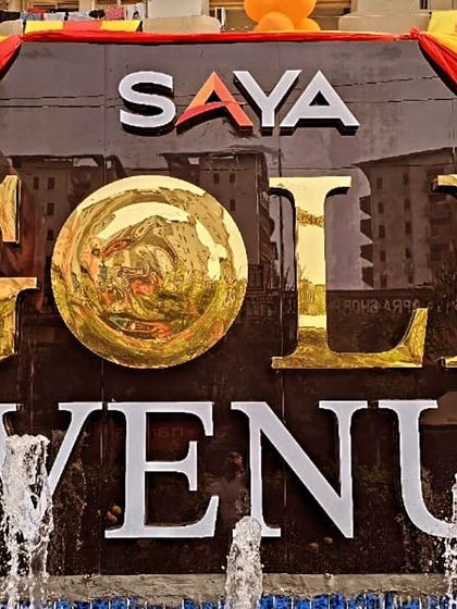 The iconic Saya Gold Avenue sign, decorated for the festive occasion of Chhath Pooja. It stands as a beacon of community and celebration in Indirapuram.