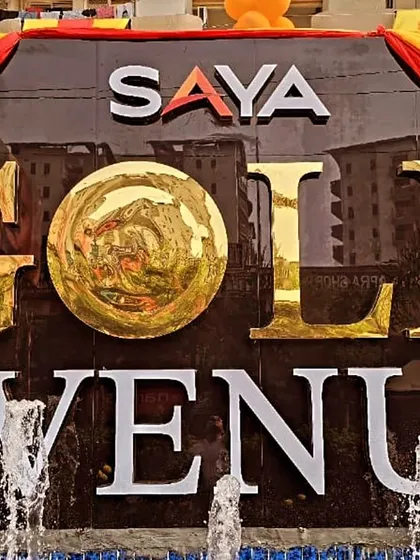 The iconic Saya Gold Avenue sign, decorated for the festive occasion of Chhath Pooja. It stands as a beacon of community and celebration in Indirapuram.