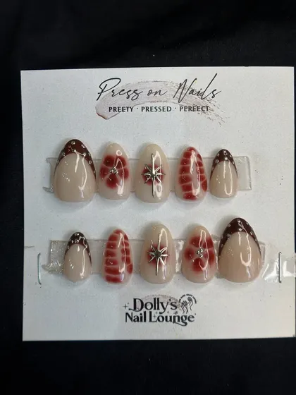 A beautiful festive press-on set with delicate silver bows and red plaid-inspired patterns on a sheer, shimmery base.