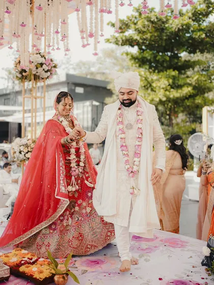 The first steps as husband and wife. We capture the couple walking together after their pheras, surrounded by family and beautiful decor.