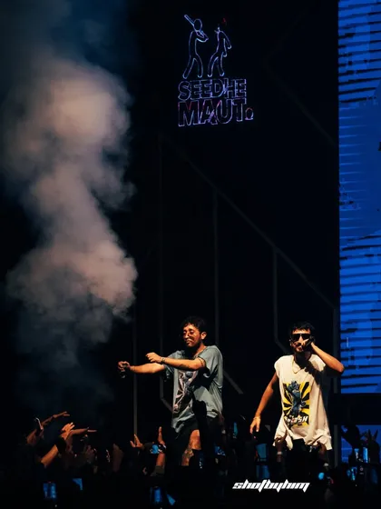 Seedhe Maut electrifies the crowd in Jaipur, blasting a smoke cannon into the audience. This shot captures the duo's signature high-octane energy and their interaction with a hyped-up fanbase.