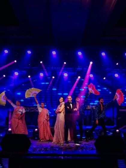 A family performance with colorful fans as props, creating a vibrant and festive look on stage.