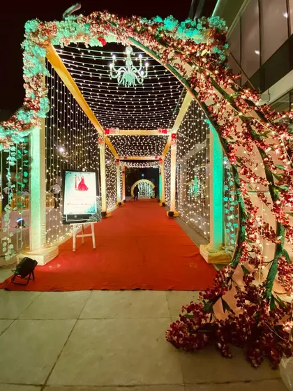 Another shot of the cherry blossom and fairy light entrance, showing the warm glow it casts on the red carpet.