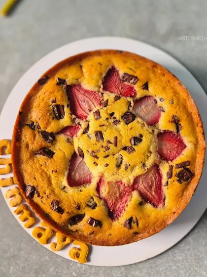 This is my Fresh Strawberry Vanilla Chocolate Tea-Time Cake. It's a simple, rustic cake with a moist vanilla sponge, loaded with fresh strawberry slices and rich chocolate chunks.