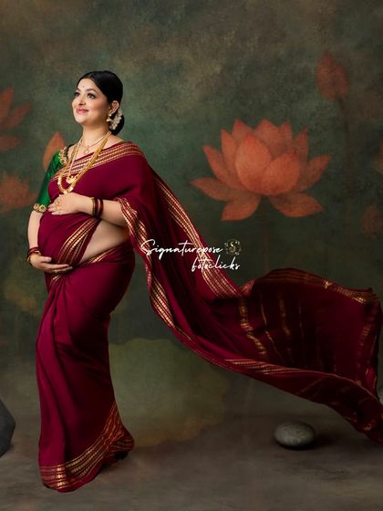 The flowing saree against a painted lotus background creates a beautiful, artistic, and distinctly Indian portrait.