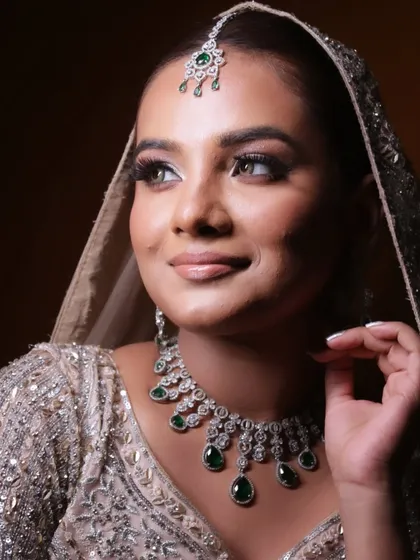 The elegance of a side profile. This view shows the delicate maang tikka and how the makeup enhances the bride's features.
