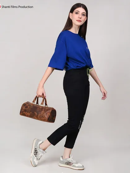 A dynamic, in-motion shot of a model with a small duffle bag. This style of photography is great for social media and ads, conveying a sense of energy and style.