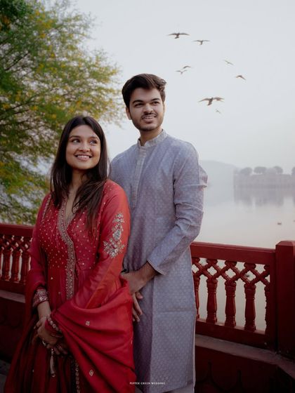 A candid moment of happiness with birds taking flight over the lake in Jaipur. These unscripted moments add life and soul to a pre-wedding collection.